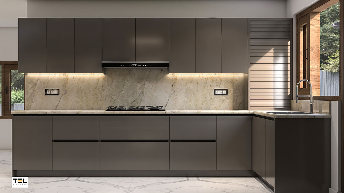 A handleless L-shaped modular kitchen design in glossy cool grey.